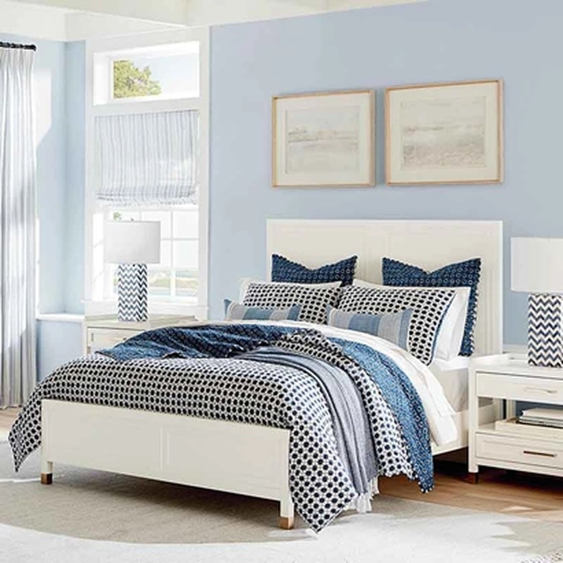 A Bassett bedroom with a white bed and patterned bedding